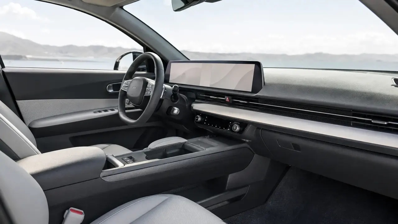 Modern car interior with a wide dashboard touchscreen, illustrating the infotainment systems examined in connected-car data research